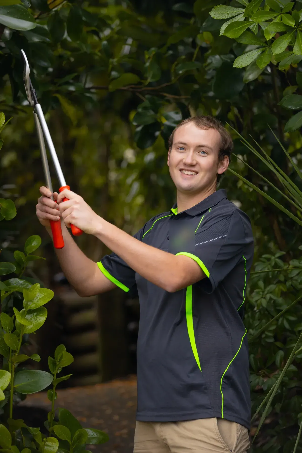 Eric Missen, owner of All Incredible Property Services, trimming a hedge